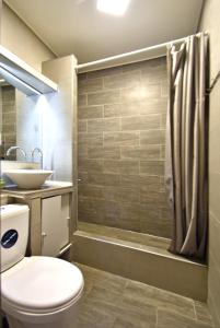 a bathroom with a toilet and a sink and a shower at 7/1Exellent apartment in the center of the capital in Yerevan