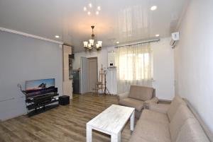 a living room with a couch and a tv at 7/1Exellent apartment in the center of the capital in Yerevan