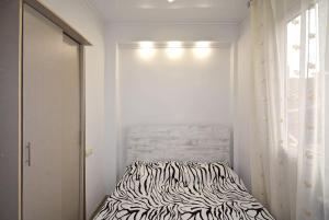 a zebra print bed in a room with a window at 7/1Exellent apartment in the center of the capital in Yerevan