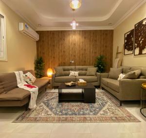 a living room with couches and a coffee table at Bohemian style in Abha