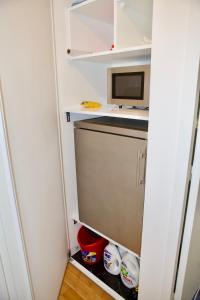 una pequeña cocina con nevera y microondas en STUDIO JASMIN en París