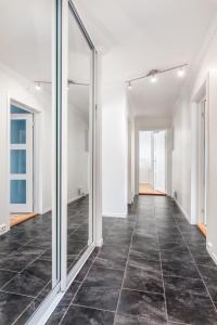 an empty corridor with mirrors in an office building at Ålesund Urban - Spacious and luminous 100 m2 urban flat with 3 large bedrooms in Ålesund