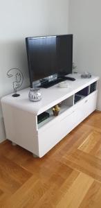 a white entertainment center with a flat screen tv on it at Apartman Aura in Zagreb