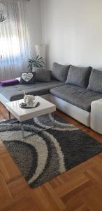 a living room with a couch and a coffee table at Apartman Aura in Zagreb