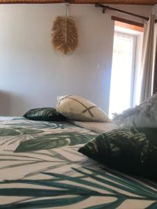 a bedroom with a bed with pillows on it at les gîtes de La Cossais in Saint-Cyr-en-Talmondais +15 photos