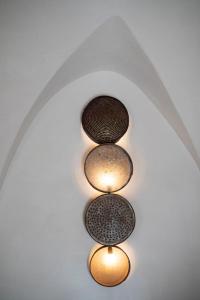 a group of three lights on a ceiling at Casetta del vicolo orologio in Cisternino