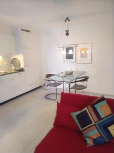 a living room with a red couch and a table at Swiss Borzoi House in Bellerive