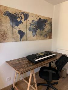 a desk with a keyboard and a map on the wall at Jojo House Les Damps n 12 in Les Damps