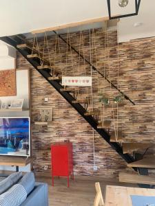a staircase in a living room with a brick wall at Jojo House Les Damps n 12 in Les Damps