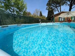 a large swimming pool with blue water at CHALET IL GELSOMINO DELL'ETNA in Giarre