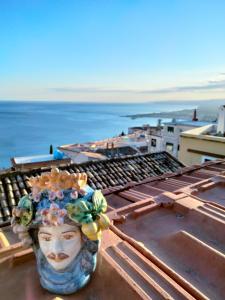 a vase sitting on top of a roof at Taormina Center Private Apartments By Fragranza Di Sicilia in Taormina