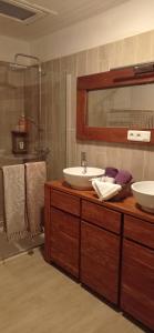 a bathroom with two sinks and a mirror at Les chambres du magnolia in Canet