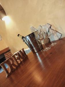 a wooden table with wine glasses on top of it at COUNTRYSIDE SUITE in Ceprano
