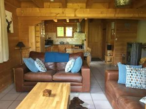 a living room with a couch and a table at Chalet Olimon in Saint-Jean-dʼAulps