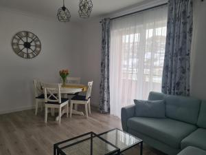 a living room with a couch and a table at Apartament Crai in Zărneşti