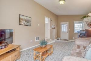 a living room with a couch and a tv at By The Sea in Lincoln City