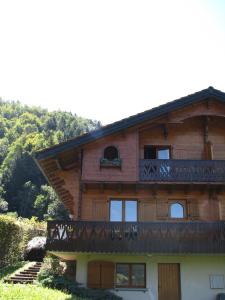 a large wooden house with a balcony on it at Chalet Olimon in Saint-Jean-dʼAulps