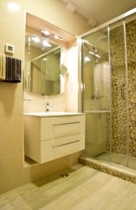 a bathroom with a sink and a glass shower at Villa Ragusa Vecchia in Dubrovnik