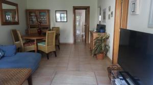 a hallway with a living room and a dining room at Garden Villa, Cosy House by the sea in Praia Verde