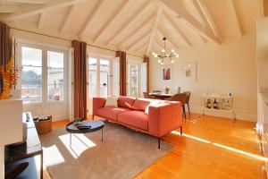 a living room with a red couch and a table at Wonderful Porto Design Apartments in Porto