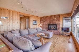 a living room with a couch and a fireplace at Sea Lyons in Lincoln City