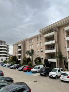 a parking lot with cars parked in front of buildings at Joli T2 récent 'Le VIVALDI' in Ajaccio