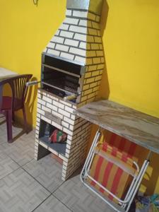 a model of a kitchen with a brick oven at Mongaguá House in Mongaguá