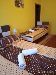 A bed or beds in a room at Örségkapuja Vendégház