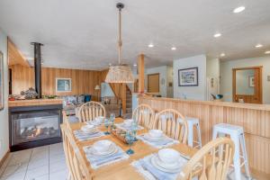 a dining room with a table and chairs and a fireplace at Summerhouse Cottage in Pacific City