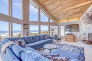 a living room with a blue couch and a fireplace at Neptune Lookout in Lincoln City