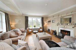a living room with couches and a fireplace at Willowvale in Nairn