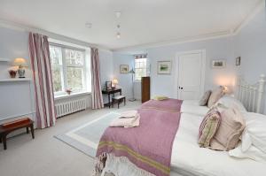 a bedroom with a large bed with a purple blanket at Willowvale in Nairn