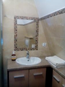 a bathroom with a sink and a mirror at domek 6 osobowy- Jezioro nyskie in Głębinów +16 photos