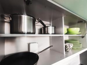 a kitchen with a sink and a pot on a shelf at Debaixo das Estrelas in Aveiro