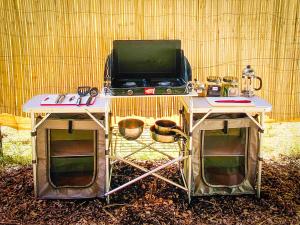 a table with a tv on top of it at Glamping in the Redwoods in Garberville