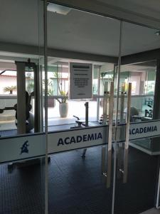 a sign that reads acardiana in front of a glass door at Apart um dormitório com vista para estrada da rainha in Balneário Camboriú +23 photos
