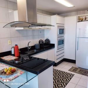 a kitchen with a sink and a stove top oven at Pousada aconchegante Apartamento inteiro in São Joaquim