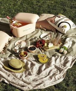 a picnic blanket with a picnic basket and food on it at La casita "A de Naval" in Pontevedra