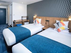 Postel nebo postele na pokoji v ubytování HOTEL MYSTAYS Soga