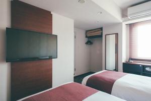 En eller flere senge i et værelse på Hotel Kuretakeso Takayama Ekimae