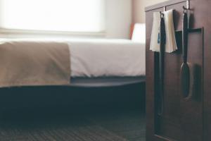 En eller flere senge i et værelse på Hotel Kuretakeso Takayama Ekimae
