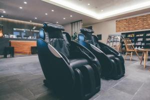 a row of black leather seats in a store at Hotel Kuretakeso Takayama Ekimae in Takayama