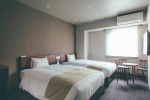 En eller flere senge i et værelse på Hotel Kuretakeso Takayama Ekimae