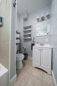 a white bathroom with a toilet and a sink at Robin's Nest - Miami U, Weddings or Spooky Nook! in Hamilton +12 photos