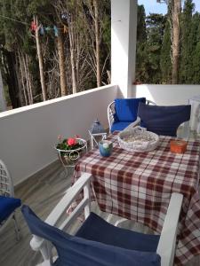 een patio met een tafel en stoelen op een balkon bij Kiki's apartment huge balcony dream in Chrissi Akti