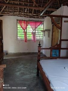 a bedroom with a bed and a window with pink curtains at Room in BB - Mida Creek Eco Camp 1 