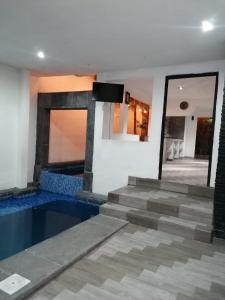 a house with a swimming pool and a mirror at Black & White casa privada con alberca in Monterrey