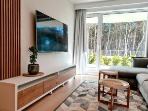 a living room with a couch and a table at Apartment 1007 Rogowo Pearl in Mrzeżyno