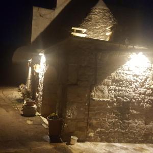 a stone building with lights on it at night at Il Trullo di Nonna Lella in Castellana Grotte