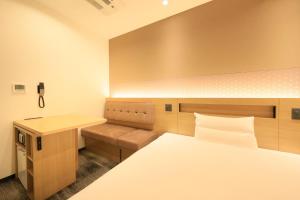 a room with a bed and a desk and a bed sidx sidx sidx at Via Inn Prime Akasaka in Tokyo